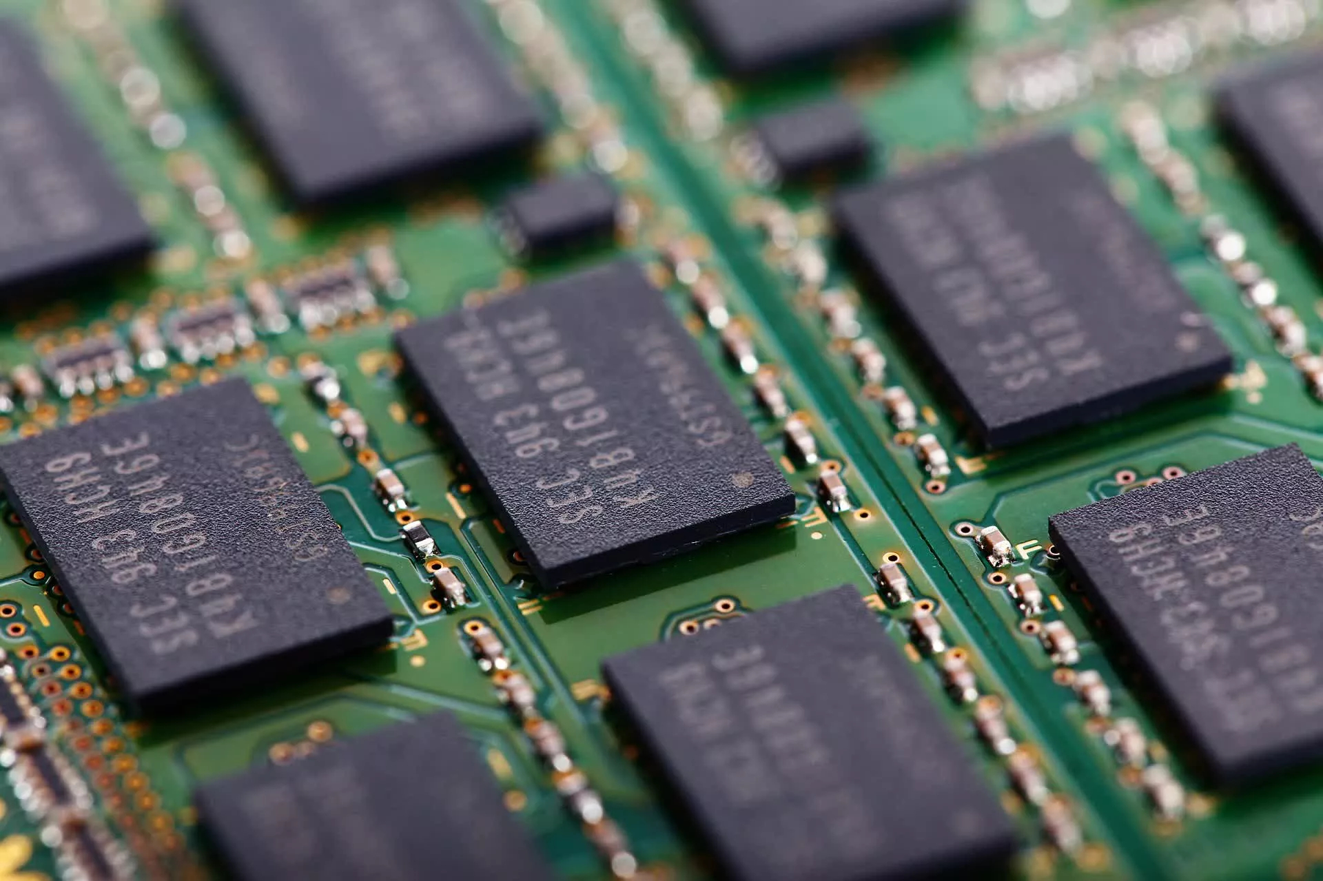 Extreme macro shot of RAM chips soldered onto a circuit board.
